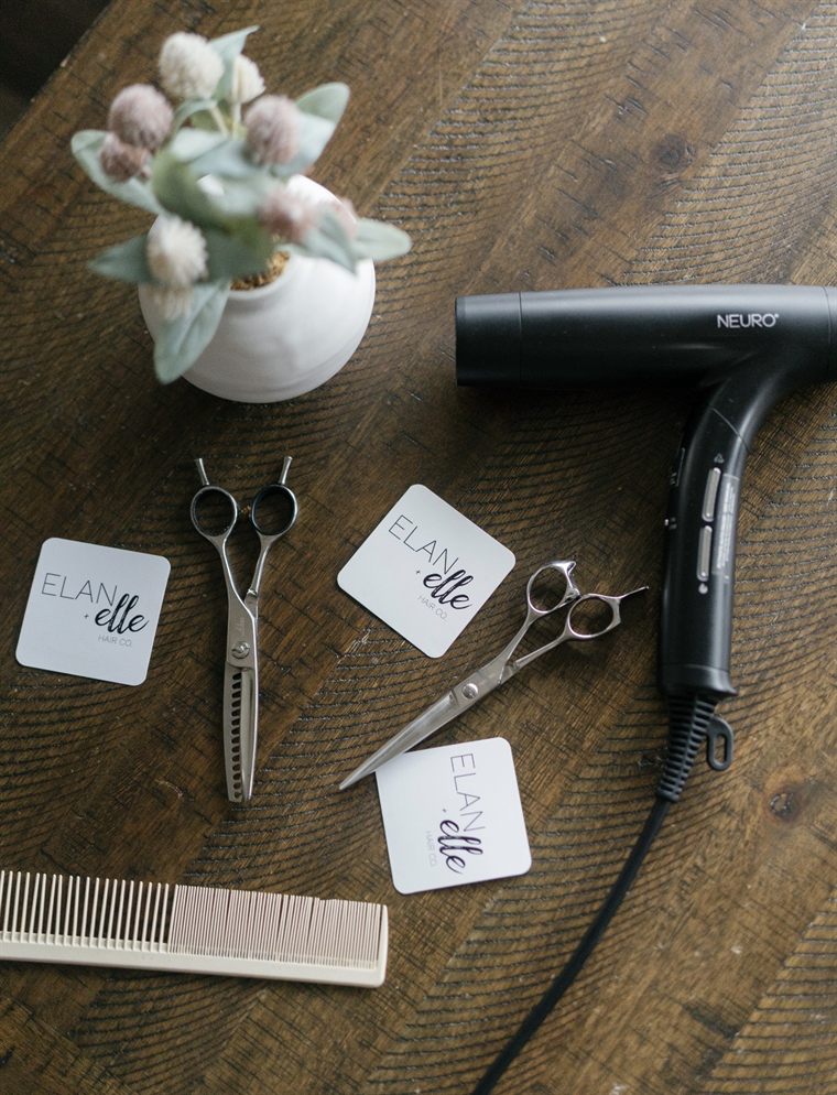 Shears, comb and dryer on the salon table